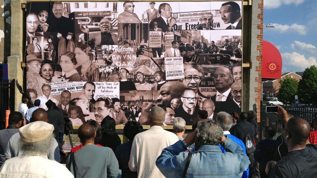 A crowd in front of a mural on May 3, 2014