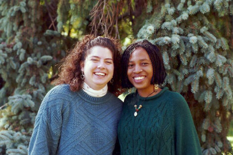 Two women are smiling at the camera.